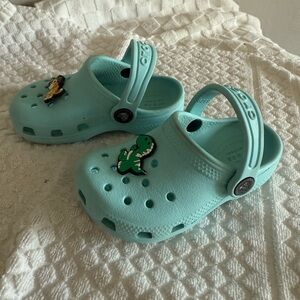 CROCS Kids Light Blue Clogs with Dinosaur Charm